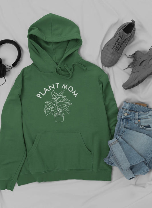 Green hoodie with 'Plant Mom' text and plant graphic, paired with jeans and shoes on a light gray background.